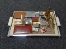A mid twentieth century chrome frame tray containing assorted brass ornaments,