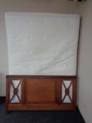 A 4'6" Ikea Hyllestad memory foam mattress with wooden bed head