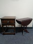 An oak single drawer side table on raised legs,