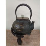 A Japanese cast iron teapot with gold inlay depicting stalks,