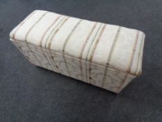 An early twentieth century blanket box upholstered in a regency stripe fabric