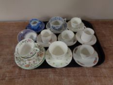 A tray containing 20th century coffee cans, teacups and saucers, to include Royal Worcester,