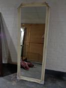 A 6' by 2' mirror in cream swept frame