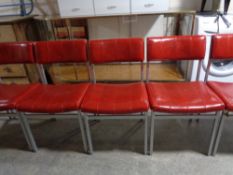 A set of eight 20th century metal framed chairs upholstered in a red vinyl