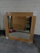 A square contemporary oak framed mirror