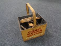 A vintage metal shoe-shine caddy containing brushes and bearing Cherry Blossom decoration