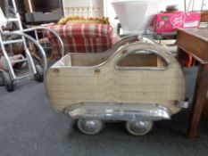 A 1930's Art Deco chrome pram in the form of a car