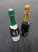 A bottle of Audinot Grand Cru champagne together with a further bottle of Cava