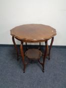 A shaped Edwardian mahogany two tier occasional table