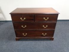 A George III style mahogany chest of drawers with brass drop handles