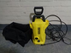 A Karcher pressure washer with attachments