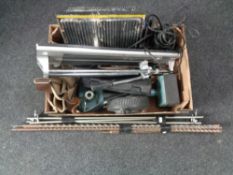 A box containing tile cutters, extension leads, carpet fitter,
