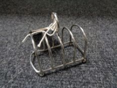 A silver miniature letter rack