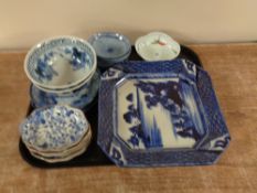 A tray containing an antique Chinese blue and white salt glazed shallow dish together with further