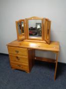 A pine single pedestal dressing table with triple mirror