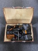 A vintage Revelation case containing assorted vintage cameras,