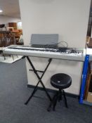 A Casio Privia PX-110 electric keyboard on stand with stool