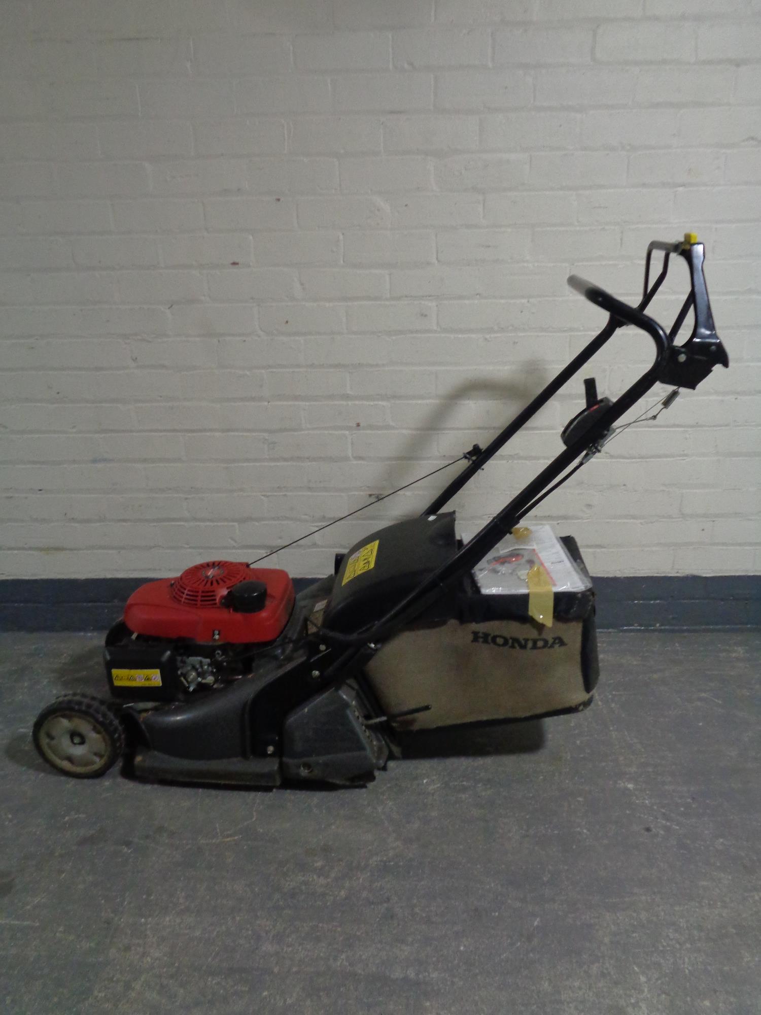 A Honda HRX self drive petrol lawn mower with grass box