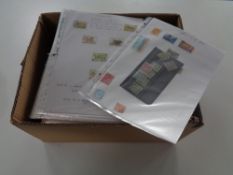 A box containing a large quantity of stamps of the world on paper in slip covers
