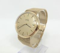 A good gent's 9ct gold Omega automatic calendar centre seconds wristwatch on textured 9ct gold