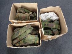 Three boxes containing military webbing and pouches