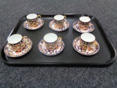 A tray containing three Royal Crown Derby Imari pattern cups and saucers