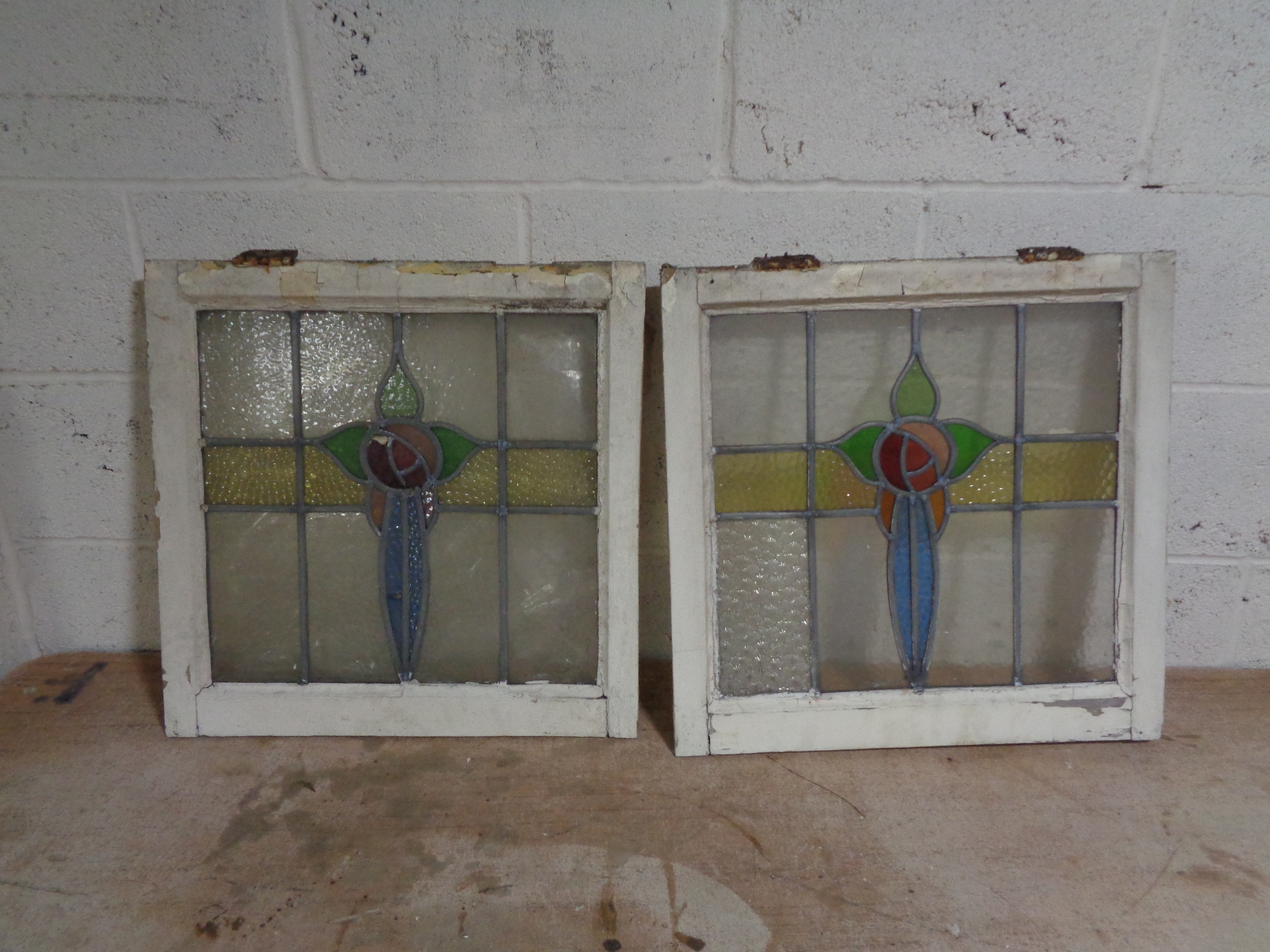 Ten framed antique stained glass windows