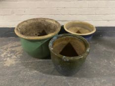 A pair of terracotta planters together with three further glazed pottery planters