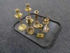 A tray containing three pairs of twentieth century brass candlesticks together with a three way