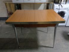 A mid 20'th Century Formica-topped Italian extending kitchen table, fitted with a drawer,
