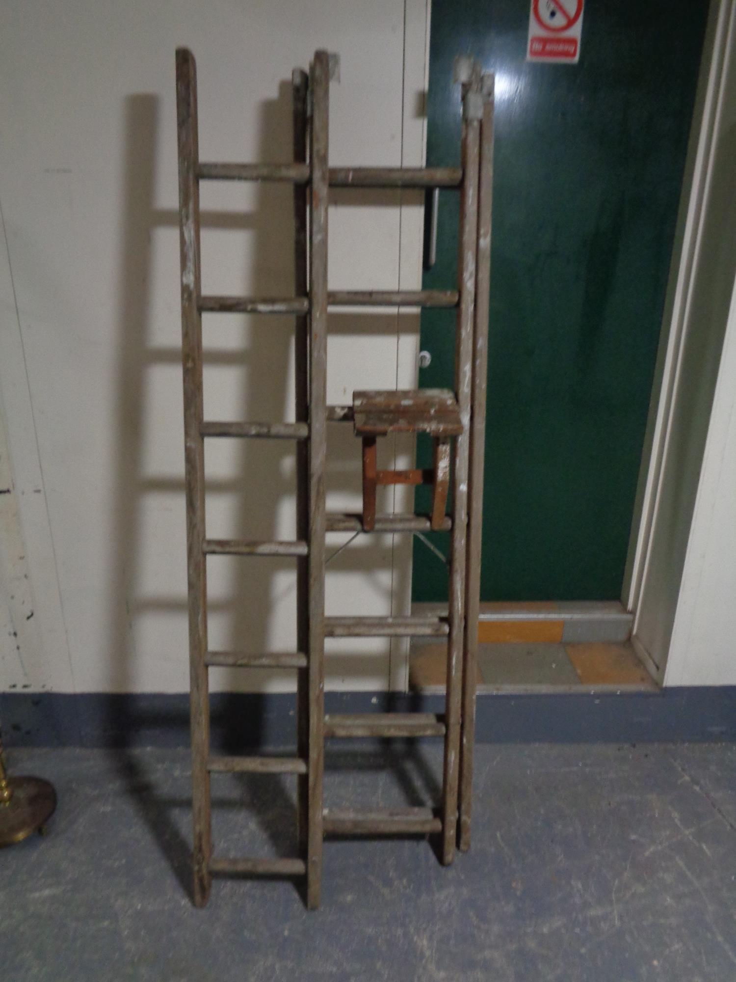 A wooden triple extension ladder
