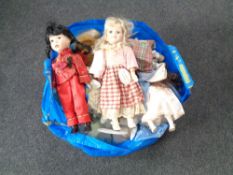 A bag containing a large quantity of porcelain headed dolls