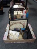 A box containing a pair of vintage leather boots with stretchers, table linen,