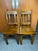 A set of four hardwood high backed dining chairs