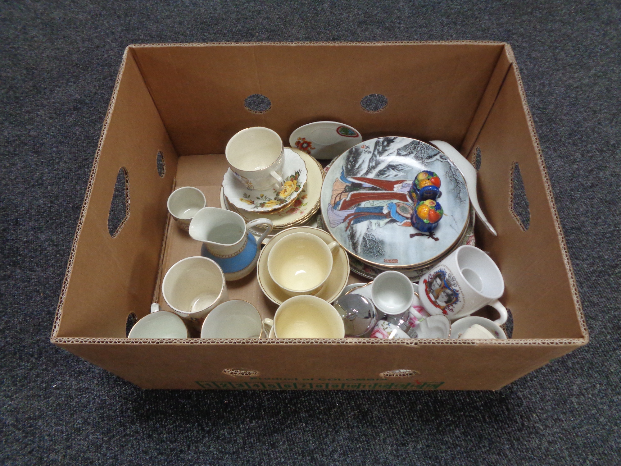 A box containing miscellaneous china to include oriental collectors plates, tea ware,