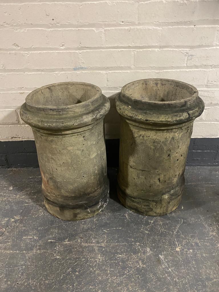 A pair of antique chimney pots