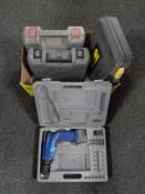 A box containing four cased power tools to include Hilka drill, no battery, performance 14.