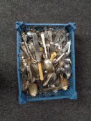A basket containing large quantity of plated and stainless steel cutlery,