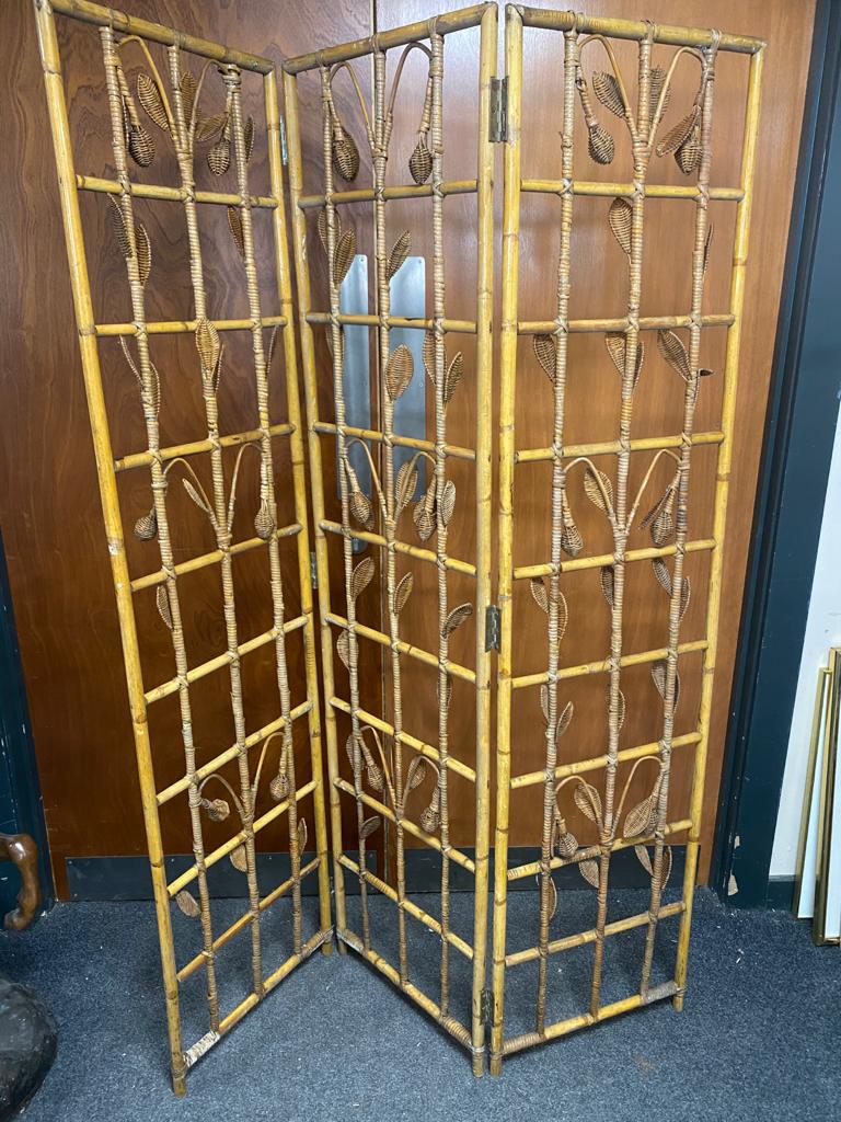 A bamboo and wicker three way folding room divider