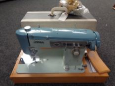 A twentieth century cased Jones sewing machine with foot pedal