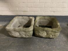A pair of concrete brick effect planters