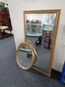 An oval decorative gilt framed mirror,