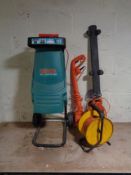 A Bosch AXT Rapid 180 garden shredder together with a Flymo electric hedge trimmer,