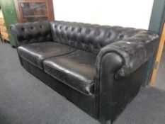 A black button leather Chesterfield settee