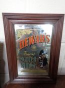 A framed Dewars Finest Scotch Whiskey advertising mirror