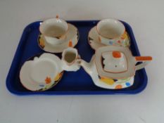 A tray containing a Myott and Sons seven piece hand painted tea for two