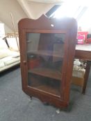 A stained pine glazed door corner display cabinet