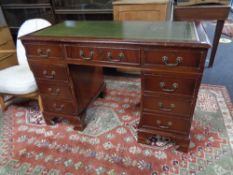 A mahogany twin pedestal desk fitted nine drawers with green tooled leather inset panel