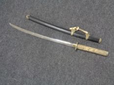 A reproduction Japanese katana with a carved plastic handle
