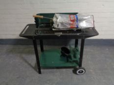 A metal barbecue with utensils